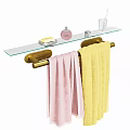 Golden Towel Rack With Glass Shelf Holding Soap Perfume Bottle And Colorful Towels
