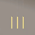 Three Yellow Long Strip Chandeliers Hanging Against Gray Background