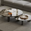 Modern Living Room With Nested Round Marble Coffee Tables Featuring Oranges Tray And Glass Cups
