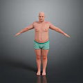 Bald Shirtless Man Standing With Arms Outstretched In Green Striped Shorts Against Gray Background