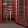 Red Telephone Booth Public Facility With Glass Door And Wooden Stool