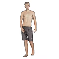 Shirtless Man Standing Barefoot in Gray Shorts Against Gray Background