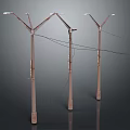 Three Rustic Utility Poles With Overhead Wires And Street Lamp Fixtures
