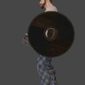 Muscular Shirtless Tattooed Man In Plaid Pants Holding Axes Standing In Neutral Background