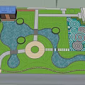 Tranquil Garden Landscape With Stone Pathway Green Trees Bushes And Walking People