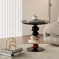 Modern Round Side Table With Stacked Colorful Round Base And Book Cup In Living Room