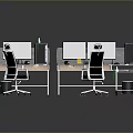Modern Office Workspace Featuring Dual Computer Monitors And Ergonomic Desk Chairs