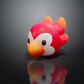 Red Orange Bird Toy With White Face Black Eyes On Black Surface With Reflection