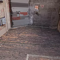 Living Supplies Including Air Conditioner Units in Narrow Alley Red Brick Flooring Old Weathered Walls