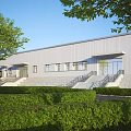 Modern Industrial Factory Building With Grey Metal Exterior Green Trees Shrubs Glass Doors And Windows