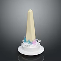 Tall Beige Obelisk Structure With Blue And Pink Decorative Elements On White Circular Base