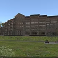 Hotel Building With Wooden And Stone Exterior In Green Natural Surroundings With Lawn And Trees