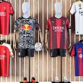 Different Football Team Jerseys Displayed On Mannequins And Hanging On Wooden Wall