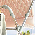 Foldable Metal Clothes Drying Rack With Hanging Clothes And Pink Blanket On Balcony