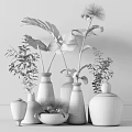 Decorative Glass Vases With Green Plants And Monstera Leaves In White Containers