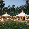 Idyllic Campsite With White Tents Lush Trees Grassland Bonfire And String Lights