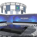 XCIND Modern Stage with Blue Lighting Illuminated Pillars and Audience Seats
