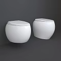Two White Modern Toilets Placed Against Gray Wall In Neutral Background