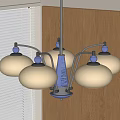 Chandelier with cream colored shades and blue accents above wooden wall with window blinds