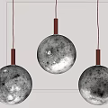 Three Moon Surface Texture Pendant Lights with Red Metal Rods Hanging in Modern Interior Design