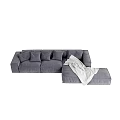 Plush Gray Sectional Sofa with Multiple Cushions Ottoman and White Blanket in Living Room