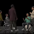 Group of People Interacting with One in Wheelchair and Another on Exercise Ball