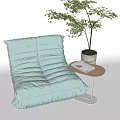 Light Green Bean Bag Sofa With Small Side Table Book And Potted Plant