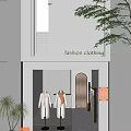 Fashion Clothing Storefront With White Facade Mannequins And Golden Door Signage