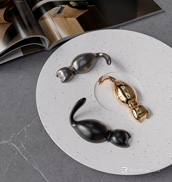 Black and Gold Curved Hooks on White Speckled Plate with Open Magazine and Gray Countertop 3d model 