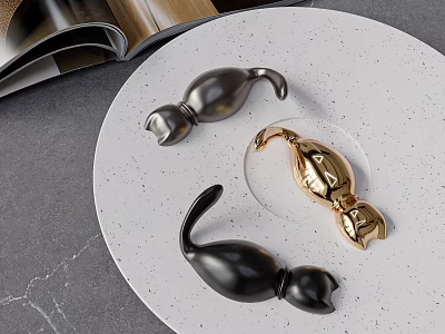 Black and Gold Curved Hooks on White Speckled Plate with Open Magazine and Gray Countertop 3d model
