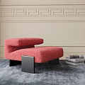 Red Fuzzy Ottoman With Black Legs On Gray Rug And Stacked Magazines