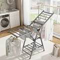 Gray Foldable Metal Clothes Drying Rack With Hanging Clothes And Shoes In Indoor Laundry Area