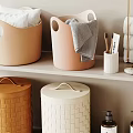Neatly Stacked Towels In Bathroom With Storage Baskets And Toiletries