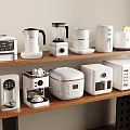 Various Modern White Kitchen Appliances Arranged On Wooden Shelves