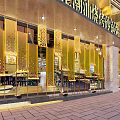 Modern Restaurant Storefront With Golden Laser Cut Partitions And Warm Lighting