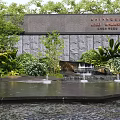 Scenic Feature Wall With Stone Texture Surrounded By Lush Greenery And Water Features