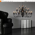 Black Chandelier With Candle Style Lights Above Open Book And Leather Sofa