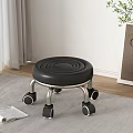 Black Circular Spiral Seat Stool With Silver Metal Legs And Wheels In Living Room