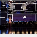 Futuristic Bar Interior With Purple Lighting Stage Neon Lights Background Screen And Person Silhouette