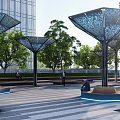 Modern Artistic Landscape Sculpture With Lattice Metal Design In Outdoor Park With Trees And Seating
