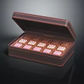 Delicious Open Chocolate Box With Pink And White Square Shaped Candies
