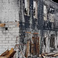 Burned Building Exterior With Damaged Walls Broken Windows Fallen Bricks And Debris At Entrance