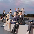 Group of People Relaxing Outdoor Evening Sitting on Benches with Sunset Sky and Smartphones