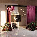 Elegant Floral Installation With Black Frame Purple Curtains And Logo Sign