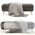 Dark Gray Vertical Tufted Sofa Stool With Golden Legs And Fringed Blanket