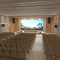 Spacious Cultural Center Hall With Rows Of Seats And Large Projection Screen