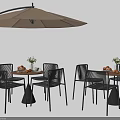 Outdoor Table Set With Black Chairs Umbrella Flower Arrangement And Fruits