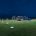 Favorware Outdoor Vehicle Display With Orange And Blue Cars Showcased On Grass Field At Sunset