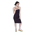 A Woman in Dark Strappy Dress With Colorful Platform Sandals Against Black Background