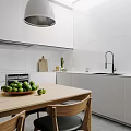 Minimalist Modern Kitchen Interior With White Cabinets Walls Pendant Light Wooden Table And Green Fruits